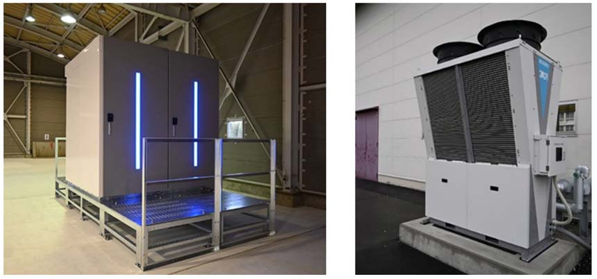 Indoor industrial cabinet on a raised metal platform in a warehouse, with two vertical blue LED strips along its doors.